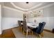 Dining room with tray ceiling, statement lighting, wainscoting, and a stylish rug at 5230 Harris Springs Dr, Cumming, GA 30040
