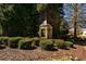 Stone community sign surrounded by manicured landscaping creates an inviting neighborhood entrance at 5230 Harris Springs Dr, Cumming, GA 30040