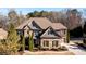 Charming two-story stone and brick home featuring well-maintained landscaping and inviting curb appeal at 5230 Harris Springs Dr, Cumming, GA 30040