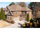 Beautiful brick home with a two-car garage and well-manicured landscaping and driveway at 5230 Harris Springs Dr, Cumming, GA 30040