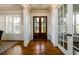 Elegant foyer with hardwood floors, white trim, and natural light from multiple windows at 5230 Harris Springs Dr, Cumming, GA 30040