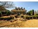 Charming home featuring a manicured lawn and inviting front porch with landscaped flowerbeds at 5230 Harris Springs Dr, Cumming, GA 30040