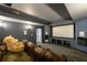 Home theater with leather reclining chairs, surround sound speakers, and a large projector screen at 5230 Harris Springs Dr, Cumming, GA 30040