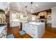Open-concept kitchen with a large island, stainless steel appliances, and hardwood flooring at 5230 Harris Springs Dr, Cumming, GA 30040