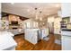 Spacious kitchen featuring a waterfall island, stainless appliances, and an eat-in breakfast bar at 5230 Harris Springs Dr, Cumming, GA 30040