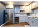 Modern kitchen with stainless steel appliances, light gray cabinetry, and a wine fridge for contemporary living at 5230 Harris Springs Dr, Cumming, GA 30040