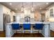 Kitchen featuring custom cabinets, a large island with bar seating, and designer pendant lights at 5230 Harris Springs Dr, Cumming, GA 30040