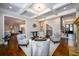 Living room with fireplace and coffered ceilings flows into the kitchen at 5230 Harris Springs Dr, Cumming, GA 30040