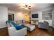 Cozy living room with a comfortable gray sofa, hardwood floors, and a ceiling fan for relaxed and stylish living at 5230 Harris Springs Dr, Cumming, GA 30040