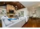 Spacious living room with stone fireplace, wood ceilings, and hardwood floors at 5230 Harris Springs Dr, Cumming, GA 30040
