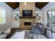 Comfortable living room with stone fireplace and access to the outdoor deck at 5230 Harris Springs Dr, Cumming, GA 30040