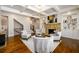Sitting room with a stone fireplace, coffered ceilings, and hardwood floors at 5230 Harris Springs Dr, Cumming, GA 30040