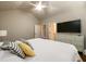 Spacious primary bedroom with high ceilings, large TV, and soothing color palette at 5230 Harris Springs Dr, Cumming, GA 30040