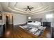 A luxurious main bedroom with stylish decor, hardwood floors, and a tray ceiling at 5230 Harris Springs Dr, Cumming, GA 30040