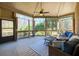 The spacious screened porch is a great place to relax and enjoy the outdoors with plenty of seating at 5230 Harris Springs Dr, Cumming, GA 30040