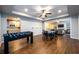 Open-concept basement with a game table and dining table adjacent to a kitchenette and living area at 5230 Harris Springs Dr, Cumming, GA 30040