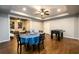 Finished basement recreation area with a game table, chair, and table with views into a separate seating room at 5230 Harris Springs Dr, Cumming, GA 30040