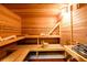 Wood sauna features wooden benches, a bucket with a ladle and a heater at 5230 Harris Springs Dr, Cumming, GA 30040