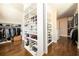 Spacious walk-in closet with custom shelving, shoe racks, and abundant storage solutions at 5230 Harris Springs Dr, Cumming, GA 30040