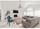 Bright, open living room with fireplace, vaulted ceiling, and modern furnishings at 101 Saddlehorn Ct, Woodstock, GA 30188