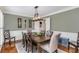 Dining room with hardwood floors, crown molding, and a modern light fixture above the table at 12065 Wexford Club Dr, Roswell, GA 30075