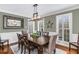 Dining room with hardwood floors, natural light, and an elegant chandelier at 12065 Wexford Club Dr, Roswell, GA 30075