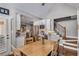 Dining area featuring hardwood floors, bright light, and views to the kitchen and staircase at 12065 Wexford Club Dr, Roswell, GA 30075