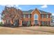 Traditional brick home featuring a symmetrical facade and a well-manicured lawn at 12065 Wexford Club Dr, Roswell, GA 30075