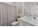 This bathroom features a shower with curtain, white cabinets, and silver hardware at 2740 Bell Se Dr, Smyrna, GA 30080
