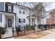 Stylish townhome featuring brick and gray siding, black shutters, and a manicured front yard at 2740 Bell Se Dr, Smyrna, GA 30080