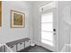Welcoming foyer with storage bench, coat rack, and modern front door with natural light at 2740 Bell Se Dr, Smyrna, GA 30080