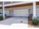 Three white garages with overhead doors and a grey brick veneer at 2740 Bell Se Dr, Smyrna, GA 30080