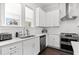Modern kitchen featuring white cabinets, subway tile backsplash, stainless steel appliances, and ample natural light at 2740 Bell Se Dr, Smyrna, GA 30080