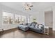 Open floor plan with hardwood floors, large windows, comfortable couch, and ceiling fan at 2740 Bell Se Dr, Smyrna, GA 30080