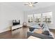 Bright living room features hardwood floors, large windows, and a comfortable sectional sofa at 2740 Bell Se Dr, Smyrna, GA 30080