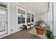 Comfortable covered back porch featuring wicker chairs, an outdoor grill, and neighborhood views at 2740 Bell Se Dr, Smyrna, GA 30080