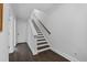 Bright stairway featuring hardwood floors and white painted risers, baseboards, and walls at 2740 Bell Se Dr, Smyrna, GA 30080