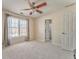 Bedroom featuring carpet, a ceiling fan, a window with curtains, and access to bathroom at 4213 Bretdale Nw Run, Kennesaw, GA 30152