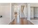 Bright entryway with hardwood floors leading to carpeted stairs and view of the living room at 4213 Bretdale Nw Run, Kennesaw, GA 30152