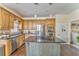 Spacious kitchen features stainless steel appliances, wood cabinets and an island at 4213 Bretdale Nw Run, Kennesaw, GA 30152