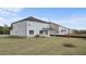 Back exterior of a two-story home with a large yard and covered patio at 604 Kimberwick Dr, Locust Grove, GA 30248