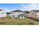 Spacious backyard with green lawn and a house with gray siding at 604 Kimberwick Dr, Locust Grove, GA 30248