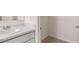 Well-lit bathroom with large sink and vanity, plus visible access to walk-in closet at 604 Kimberwick Dr, Locust Grove, GA 30248