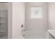 Bright bathroom with a garden tub with marble countertop and tile walls at 604 Kimberwick Dr, Locust Grove, GA 30248