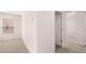 Bright bedroom with neutral carpet and large window at 604 Kimberwick Dr, Locust Grove, GA 30248