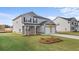 Two-story home with gray siding, brick accents, manicured lawn and an attached two car garage at 604 Kimberwick Dr, Locust Grove, GA 30248