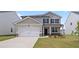 Charming home with a covered front porch, manicured lawn, and a two-car garage at 604 Kimberwick Dr, Locust Grove, GA 30248