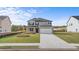 Charming two-story home with manicured lawn and neutral gray color palette at 604 Kimberwick Dr, Locust Grove, GA 30248