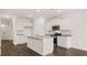 Modern kitchen features white cabinets, stainless steel appliances, granite countertops, and hardwood floors at 604 Kimberwick Dr, Locust Grove, GA 30248