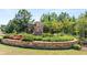Stone monument entrance to the Bridle Creek community with lush landscaping at 604 Kimberwick Dr, Locust Grove, GA 30248